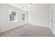 Bedroom with neutral carpet, two sunny windows, and a ceiling light at 4390 Allgood Pl, Stone Mountain, GA 30083