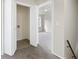 Hallway with bi-fold doors to laundry hookups and an open door to a carpeted bedroom at 4390 Allgood Pl, Stone Mountain, GA 30083