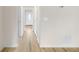 Bright hallway with fresh paint, hardwood floors, and white doors leading to various rooms at 4390 Allgood Pl, Stone Mountain, GA 30083