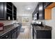 Modern kitchen featuring dark cabinets, granite countertops, and stainless steel appliances at 4390 Allgood Pl, Stone Mountain, GA 30083