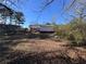 Large backyard with trees and leaves at 7480 Ambassador Dr, Riverdale, GA 30296