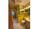 Main bathroom with yellow walls and tiled floor at 7480 Ambassador Dr, Riverdale, GA 30296