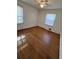 Simple bedroom with hardwood floors and window at 7480 Ambassador Dr, Riverdale, GA 30296