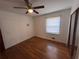 Bright bedroom featuring hardwood floors and ceiling fan at 7480 Ambassador Dr, Riverdale, GA 30296