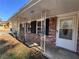 Brick ranch house with a covered porch and white door at 7480 Ambassador Dr, Riverdale, GA 30296