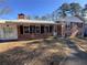 Brick ranch house with covered porch and landscaping at 7480 Ambassador Dr, Riverdale, GA 30296