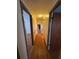 Hardwood floor hallway with access to bedrooms at 7480 Ambassador Dr, Riverdale, GA 30296
