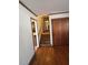 Long hallway with hardwood floors and access to upstairs at 7480 Ambassador Dr, Riverdale, GA 30296