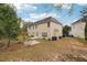 Two-story house with backyard patio and trees at 2005 Creek Pointe Way, Villa Rica, GA 30180