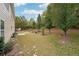 Large backyard with trees, patio, and grassy area at 2005 Creek Pointe Way, Villa Rica, GA 30180