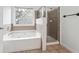 Bathroom with updated vanity, soaking tub and shower at 2005 Creek Pointe Way, Villa Rica, GA 30180