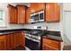 Well-equipped kitchen with stainless steel appliances and dark wood cabinets at 2005 Creek Pointe Way, Villa Rica, GA 30180