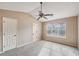 Main bedroom with ceiling fan and large window at 2426 Windridge Dr, Conyers, GA 30013