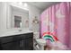 Bright bathroom with unicorn-themed shower curtain, vanity, and modern toilet at 2527 Dayview Ln, Atlanta, GA 30331