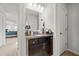 Well-lit bathroom features a vanity with granite countertop, modern fixtures, and doorway to bedroom at 2527 Dayview Ln, Atlanta, GA 30331