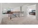 Carpeted hallway with access to loft and main bedroom, featuring a wooden staircase and iron railing at 2527 Dayview Ln, Atlanta, GA 30331