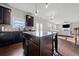 Modern kitchen boasts dark cabinets, granite countertops, and an island with seating at 2527 Dayview Ln, Atlanta, GA 30331