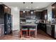 Stylish kitchen featuring a center island, granite countertops, and dark wood cabinetry at 2527 Dayview Ln, Atlanta, GA 30331