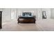 Large main bedroom with natural light, plush carpet, dark wood bed, and ensuite bathroom at 2527 Dayview Ln, Atlanta, GA 30331