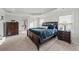 Comfortable bedroom featuring tray ceiling, plush carpet, and dark wood furniture at 2527 Dayview Ln, Atlanta, GA 30331