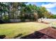 Large backyard with grassy lawn, playset, and shed at 117 Javay Ct, Villa Rica, GA 30180