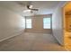 Large bedroom with two windows and carpeting, offering a serene space, and a peek into the bathroom at 2192 Landing Walk Dr, Duluth, GA 30097