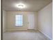 Bright bedroom featuring neutral carpet, a window with blinds, and a white door at 2192 Landing Walk Dr, Duluth, GA 30097