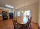 Inviting dining area featuring wood floors, an elegant light fixture, and access to the outdoor area through sliding doors at 2192 Landing Walk Dr, Duluth, GA 30097