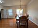 Open dining room featuring wood floors, a hanging light fixture, and access to the kitchen at 2192 Landing Walk Dr, Duluth, GA 30097