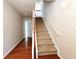 Inviting foyer with hardwood floors and staircase with wood and white accents at 2192 Landing Walk Dr, Duluth, GA 30097