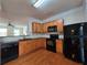 Kitchen featuring black appliances, wooden cabinets, and granite countertops at 2192 Landing Walk Dr, Duluth, GA 30097