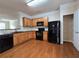 Kitchen featuring wooden cabinets, black appliances and tile backsplash at 2192 Landing Walk Dr, Duluth, GA 30097