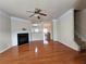 Bright living room boasts wood floors, a fireplace, and an open layout leading to the dining area and staircase at 2192 Landing Walk Dr, Duluth, GA 30097