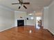 Spacious living room with hardwood floors, fireplace, and a ceiling fan at 2192 Landing Walk Dr, Duluth, GA 30097