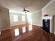 Living room featuring a fireplace, ceiling fan, crown molding and hardwood floors at 2192 Landing Walk Dr, Duluth, GA 30097