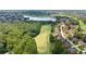 Stunning aerial view of a golf course community with a lake and lush green surroundings at 6519 Cheval Ct, Stone Mountain, GA 30087