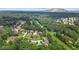 Aerial view of homes nestled in a wooded area with mountain views at 6519 Cheval Ct, Stone Mountain, GA 30087