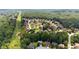 Aerial view showcasing a neighborhood nestled amidst green trees with well-maintained lawns at 6519 Cheval Ct, Stone Mountain, GA 30087