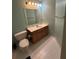 Well-lit bathroom with a large mirror, a wooden vanity, and clean tile floors at 6519 Cheval Ct, Stone Mountain, GA 30087