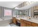 The Primary bathroom features a soaking tub, double sinks, and decorative windows for natural light at 6519 Cheval Ct, Stone Mountain, GA 30087