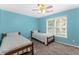 Comfortable bedroom with twin beds, a ceiling fan, and plenty of natural light at 6519 Cheval Ct, Stone Mountain, GA 30087