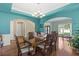 Elegant dining room with colorful walls, hardwood floors, and a decorative chandelier at 6519 Cheval Ct, Stone Mountain, GA 30087