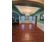 Spacious dining room featuring hardwood floors and a decorative tray ceiling with elegant lighting at 6519 Cheval Ct, Stone Mountain, GA 30087