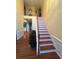 Bright entryway featuring hardwood floors, staircase, and a view of the second-floor landing at 6519 Cheval Ct, Stone Mountain, GA 30087