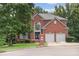 Brick front exterior of a two-story house with a two-car garage at 6519 Cheval Ct, Stone Mountain, GA 30087