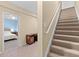 Hallway view with access to stairs and a bedroom featuring a comfortable bed and study area at 6519 Cheval Ct, Stone Mountain, GA 30087