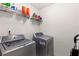 Convenient laundry room with washer, dryer, and shelving at 6519 Cheval Ct, Stone Mountain, GA 30087