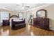 Main bedroom suite featuring hardwood floors, a king-sized bed, and elegant furnishings at 6519 Cheval Ct, Stone Mountain, GA 30087