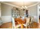 Formal dining room with hardwood floors, chandelier, and built-in hutch at 6610 Wesley Trail Holw, Cumming, GA 30028