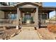 Charming front porch with wooden columns and a teal front door at 6610 Wesley Trail Holw, Cumming, GA 30028